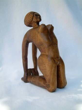 Wooden statue of a naked woman の写真素材