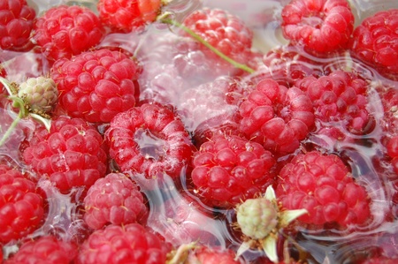 Ripe raspberries in water