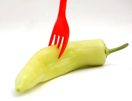 fork on green pepperの写真素材