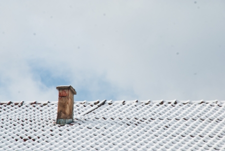 chimney in winter with snowの写真素材