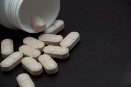  pills on black  background