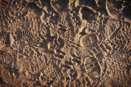 Boot prints in brown mudの写真素材