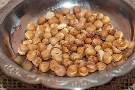 hazelnuts in metal plateの写真素材