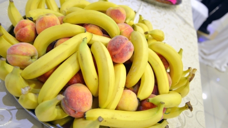 plate with bananas and peachesの写真素材