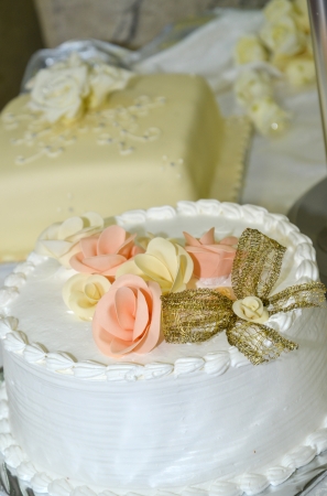 White wedding cake with colorful roseの写真素材