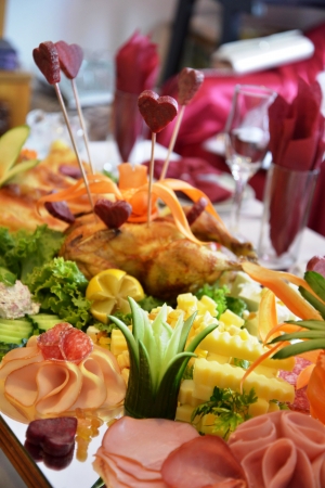Platter of assorted cold cut meat slices and vegetablesの写真素材