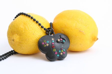 Black necklace with gems on two lemonsの写真素材