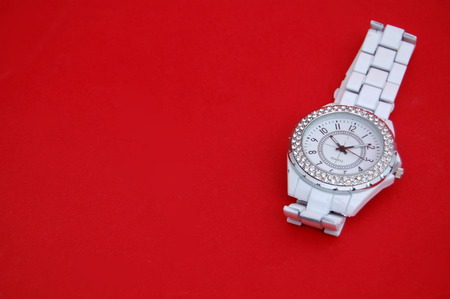 Fashion women wristwatch on red backgroundの写真素材