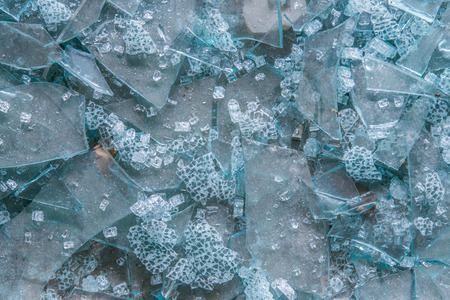 broken glass pieces on concrete