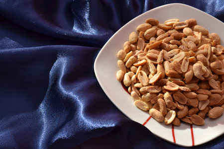 Salted peanuts on satin