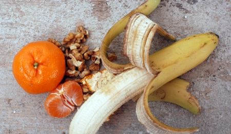 walnuts, tangerine and bananaの写真素材