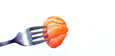 Tangerine on a forkの写真素材