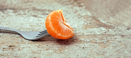 Tangerine on a forkの写真素材