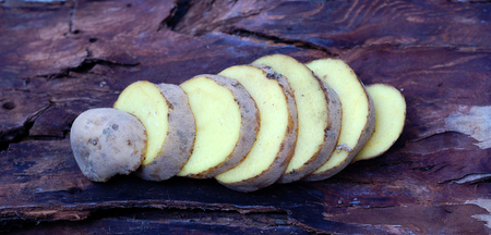 Organic potato on wooden surfaceの写真素材