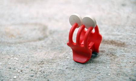 pills hold by a clip on wooden surface