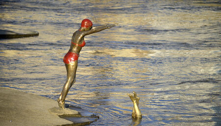 Statue of Swimmer jumping into river Vardar, skopje, macedonia のeditorial素材