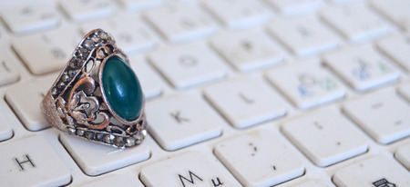Male fashion ring on white keyboard