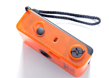 Old orange plastic compact film cameraの写真素材