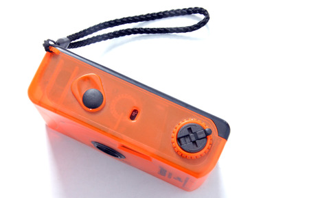 Old orange plastic compact film cameraの写真素材