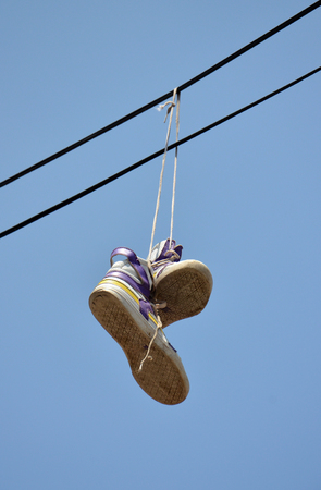 sport shoes on a electric cableの写真素材