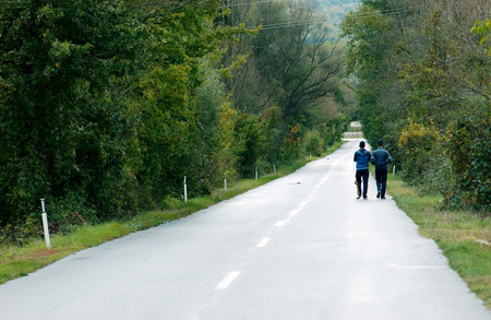 Friend on a village road walkingの写真素材