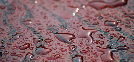 raindrops on a red table surface, photo ofの写真素材