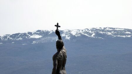 A statue in Ohrid Macedonia named Catcher of a Crossの写真素材