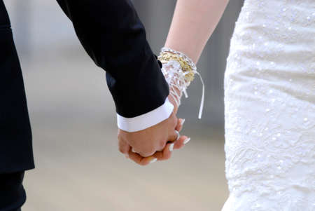 Picture of a Bride and groom holding his handsの写真素材