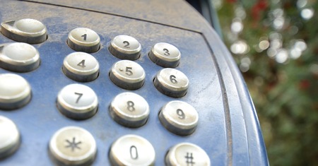 Picture of a Close up of a dirty and dusty  payphone keypadの写真素材