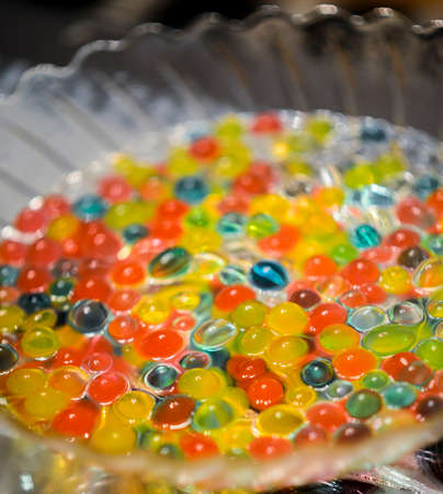 picture of a colorful beads in a water bowlの写真素材