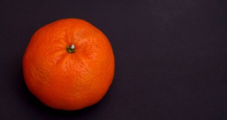 picture of an orange citrus  isolated on  a black bavkgroundの写真素材