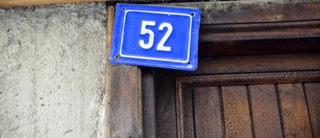 Picture of a Door numbers on a blue plateの写真素材