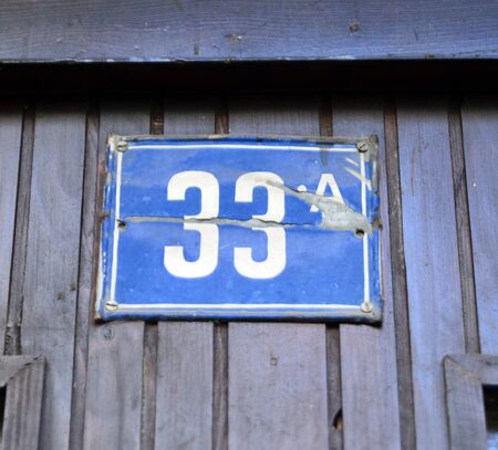 Picture of a Door numbers on a blue plateの写真素材