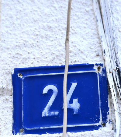 Picture of a Door numbers on a blue plateの写真素材