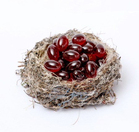 Picture of a Cod liver oil omega 3 gel capsules in sparrow nestCの写真素材