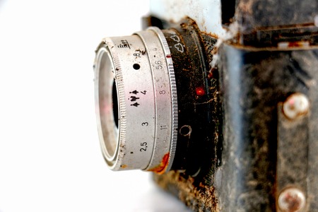 Picture of a Closeup of old retro rusty film camera on white background