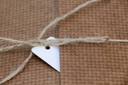 Parcel tied with string with white address label attachedの写真素材