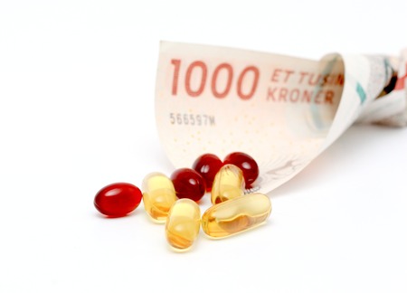 picture of a Cod liver oil omega 3 gel capsules with 1000 danish kroner currency bank note
