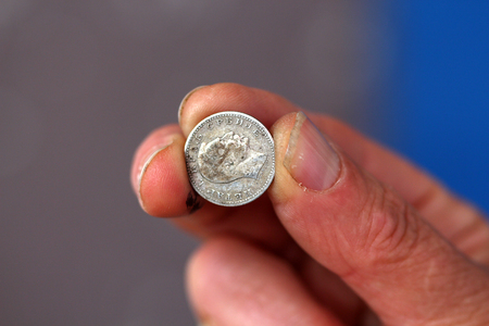 picture of a Fingers hold old coin from serbiaの写真素材