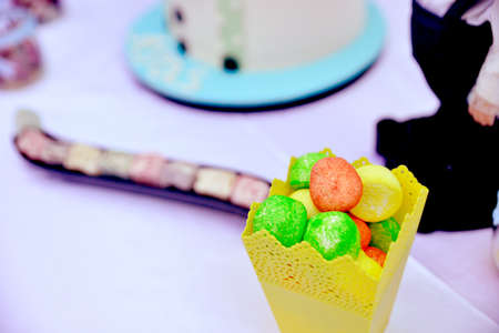 picture of a variety of fruit candies in a yellow paper bagの写真素材