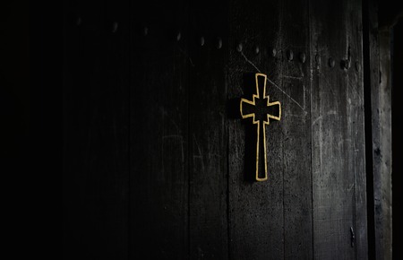 picture of a cross on a wooden church doorの写真素材