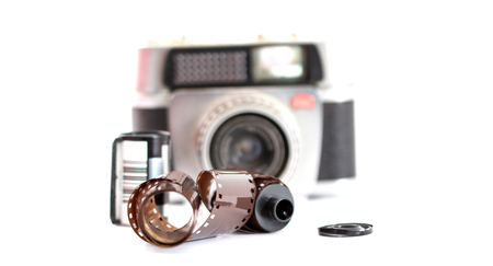 ,pictureof a vintage camera film roll on white backgroundの写真素材