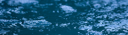 picture of bubbles on a flowing water , blue backgroundの写真素材