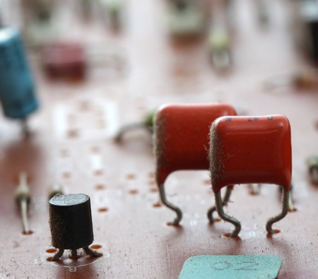 Part of old vintage printed circuit board with electronic components.の写真素材
