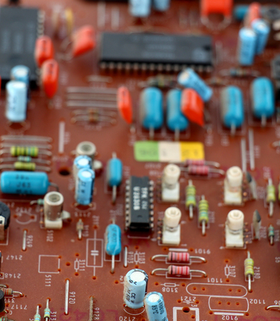 Part of old vintage printed circuit board with electronic components.の写真素材