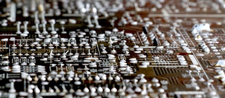 Part of old vintage printed circuit board with electronic components.
