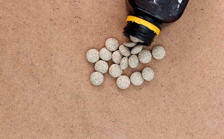 picture of a . Medicine Herbal pills , alternative drug. Natural pharmaceutical pill, . Vitamin supplement for care, medication, treatment.wood backgroundの写真素材