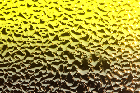 Water dew drops on glass background on the sunrise.effect addedの写真素材