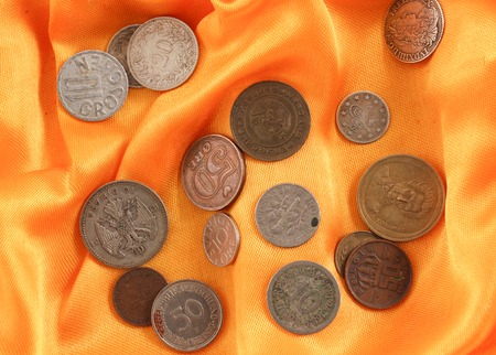 picture of an Old coins on yellow fabricの写真素材