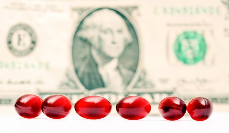 picture of a Cod liver oil omega 3 gel capsules in front of one dollar bill